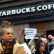 Protester Michelle Brown demonstrates outside a Center City Starbucks in Philadelphia on April 15, 2018, in the wake of the arrest of two black men who were waiting inside the Starbucks, prompting an apology from the company’s CEO.